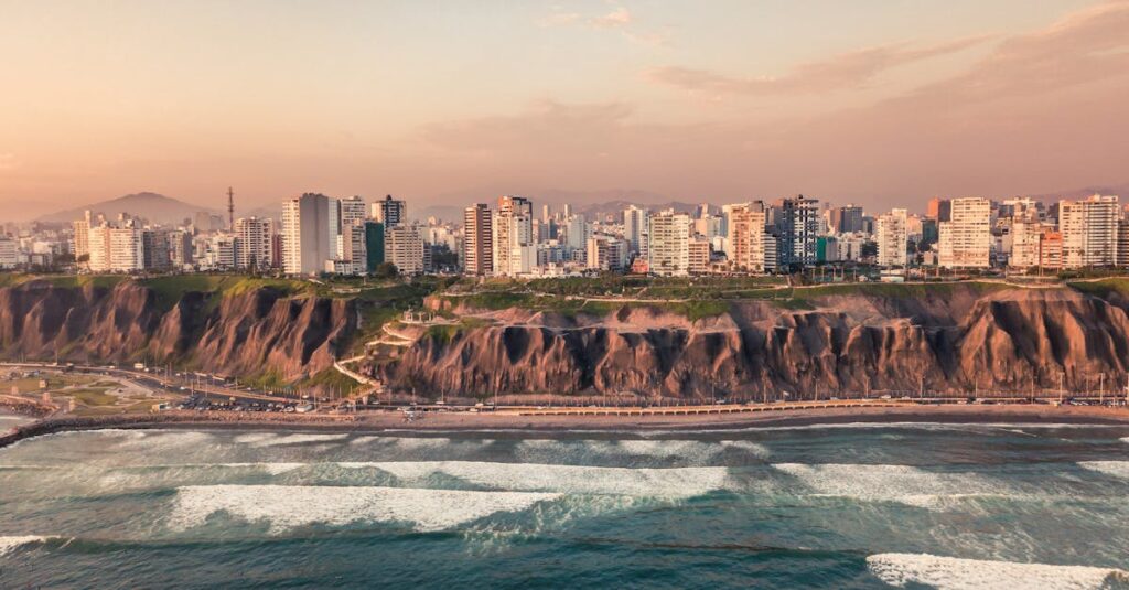 Ipsum lorem el Scenic aerial view of Lima's cliffs and Pacific Ocean coastline during sunset, highlighting urban landscape and natural beauty.